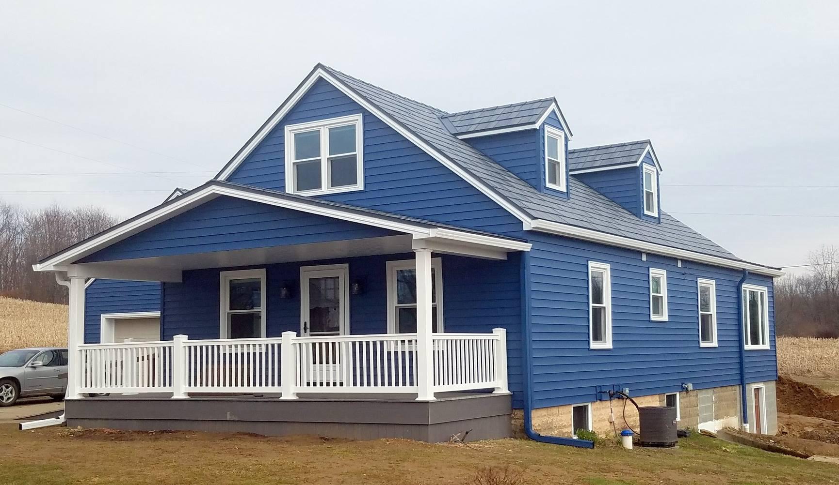 Stunning rural home the is complete with EDCO from top to bottom: Prism Traditional Lap Siding in Sapphire and the award-winning Infiniti roofing in Granite Gray Enhanced