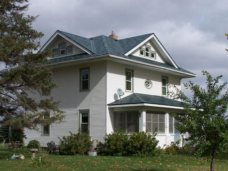 A farmhome local on an acerage outside of the Twin Cities chose Arrowline Shake Hartford Green Blend Roofing to maintain a weathered shake panel look that will last a lifetime