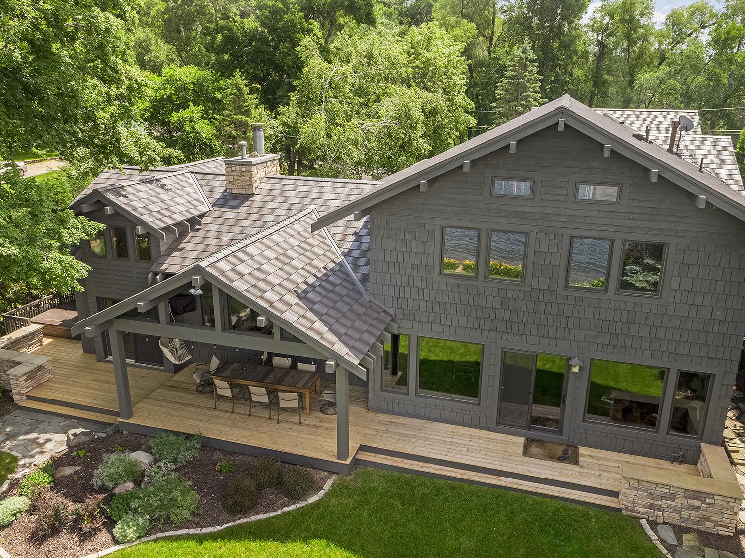 A unique rustic appearance of Infiniti Roadhouse roofing gives this home additional personality.