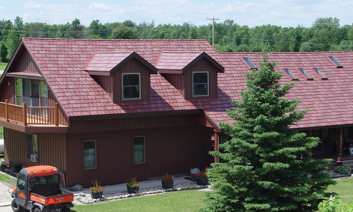Arrowline Slate Roofing in a Classic Red Blend was installed on this rural farmhouse to not only match the color of other buildings but to give the home unique character.