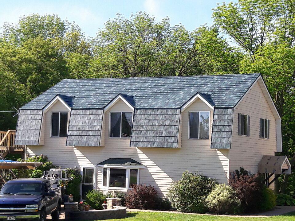 The beauty of this unique home can be found with its ArrowLine Hartford Green Enhanced Slate Roofing.