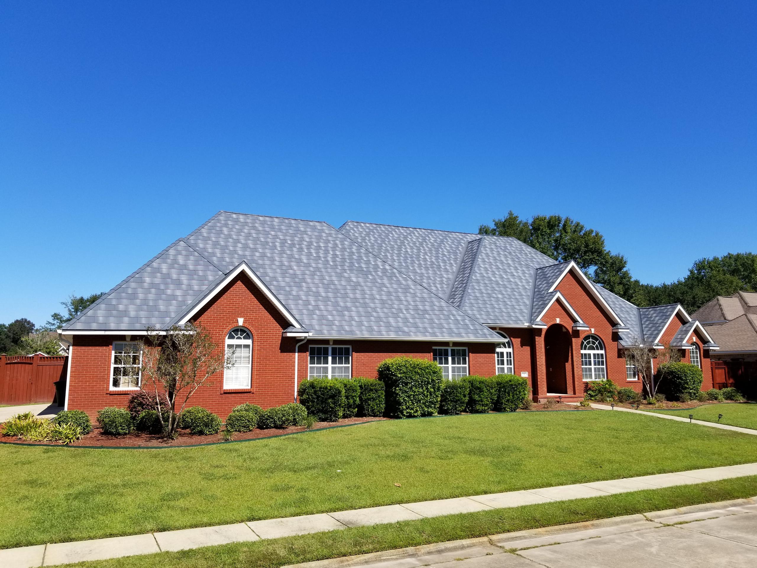 The award-winning Infiniti roofing from EDCO in Granite Gray Enhanced was selected for this red brick home to give it a distinctive appearance the is unmatched,