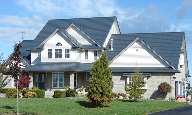 This beautiful two-story home located on an acreage showcases EDCO's slate classic blue steel roofing to give it an authentic look.