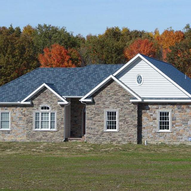 This beautiful rambler in rural Michigan with unqiue charm features the Arrowline Slate Stone Blend Roofing which achieves the look of natural slate for a fraction of the weight and cost