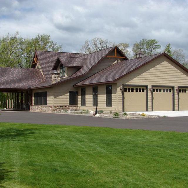 Located in rural Wisconsin, this ranch-style home selected Arrowline Shake Royal Brown Blend Roofing because of its impact resistance, which is the highest impact rating available
