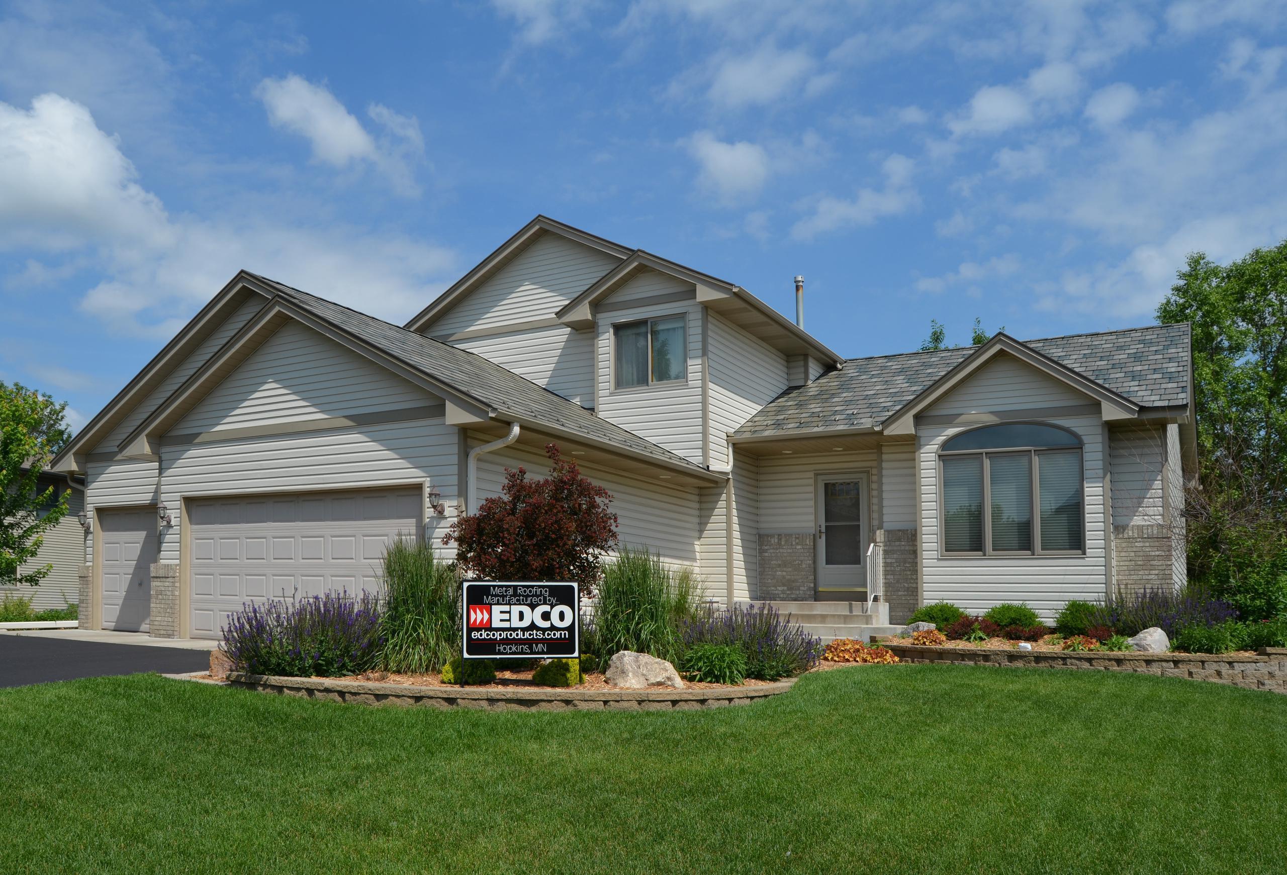 The beautiful combination of EDCO's steel roofing (Arrowline Slate in T-Tone), siding (Desert Tone) and trim (Claytone) give this home the everlasting performance expected from a superior building product