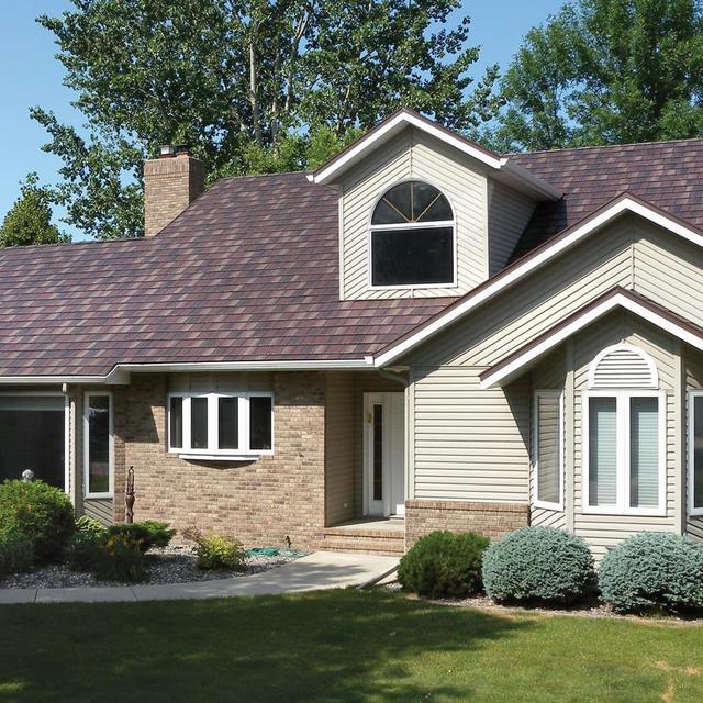 EDCO's Arrowline Shake Royal Brown Blend Roofing offers this rambler a distinctive look that coordinates with the brick and siding color on the home