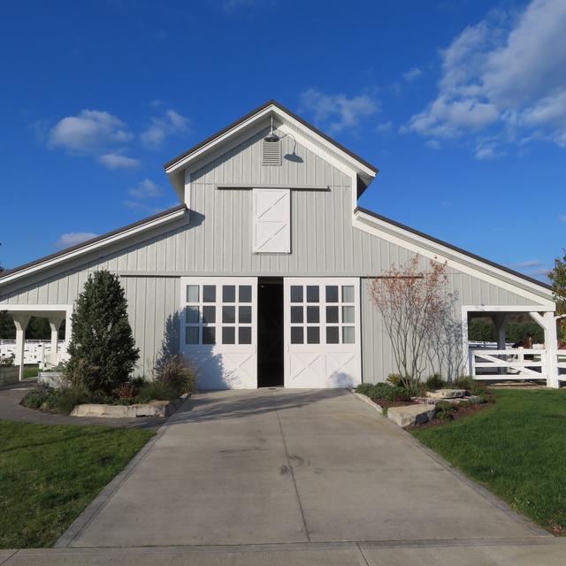 Board and Batten in Driftwood Gray was selected for this horse barn because of its durability and unique charm that it provided.