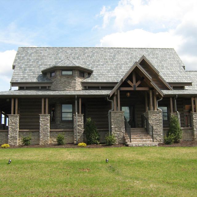 The Arrowline Slate Charcoal Gray Blend Roofing offers quality and style to the stunning look of this log cabin home.