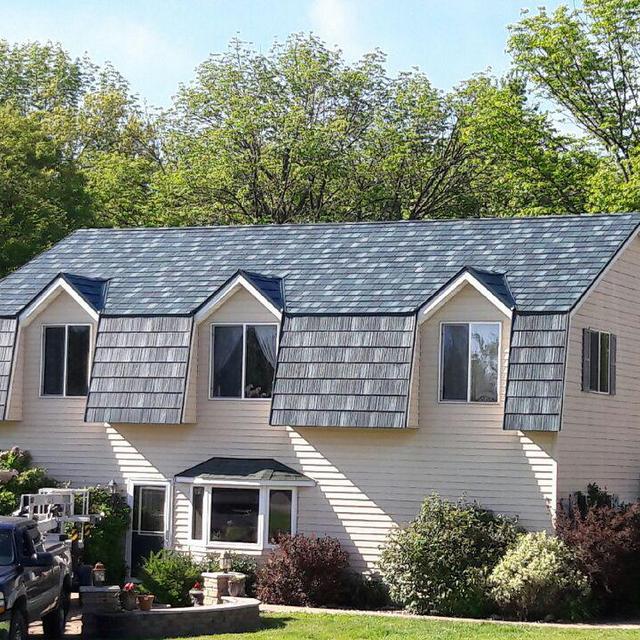 The beauty of this unique home can be found with its ArrowLine Hartford Green Enhanced Slate Roofing.
