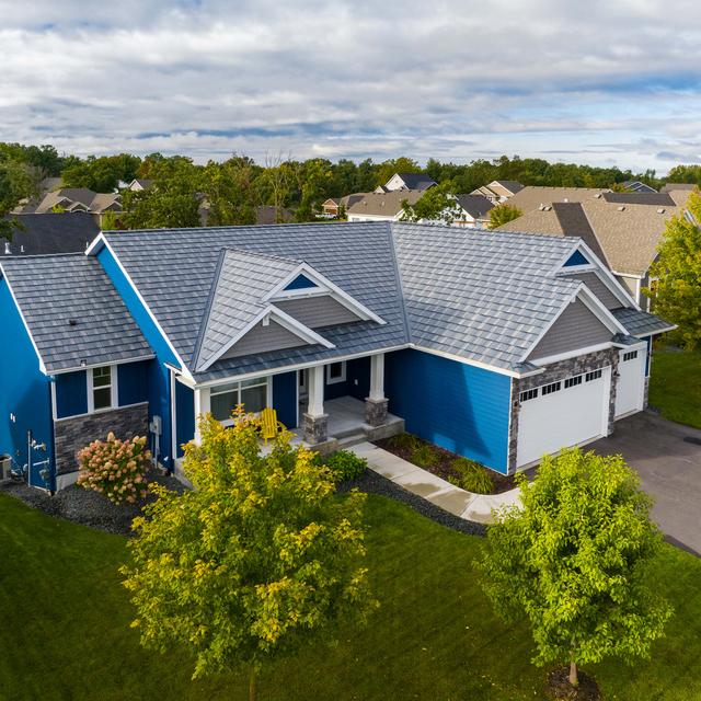 A modern home with steel shake roofing and vibrant blue siding, showcasing EDCO’s low-maintenance and durable exterior materials.